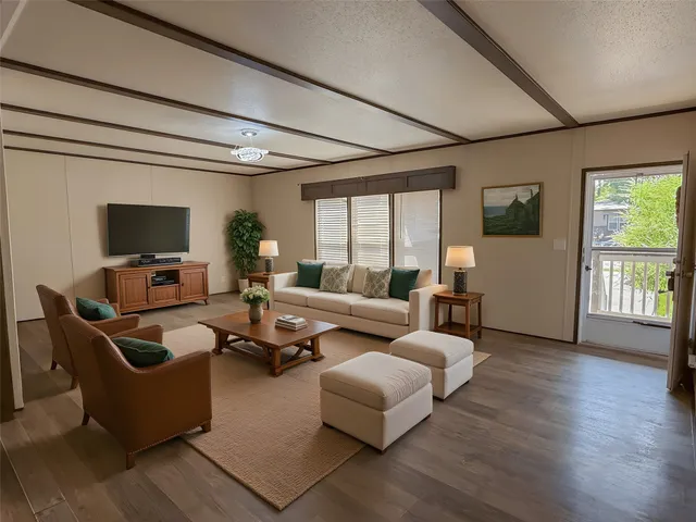 a living room with fireplace furniture and a flat screen tv