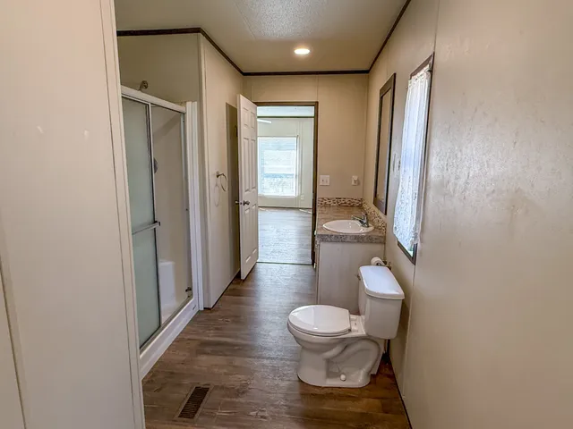 a bathroom with a toilet and a shower