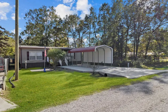 a backyard of a house with table and chairs