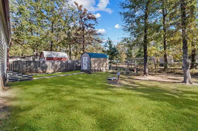 a swimming pool with outdoor seating and yard