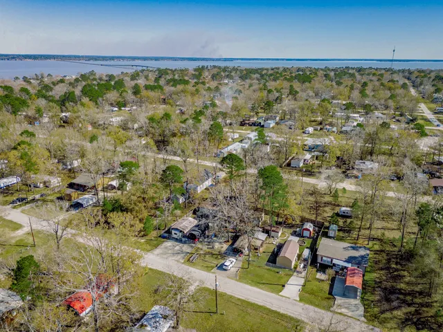 an aerial view of a house with a lake view