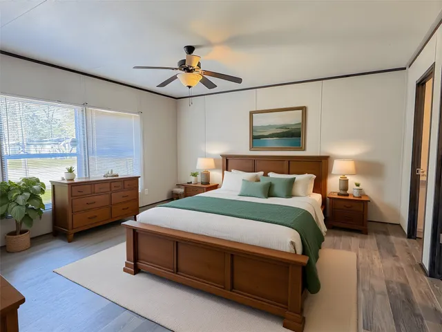 a bedroom with bed and wooden floor