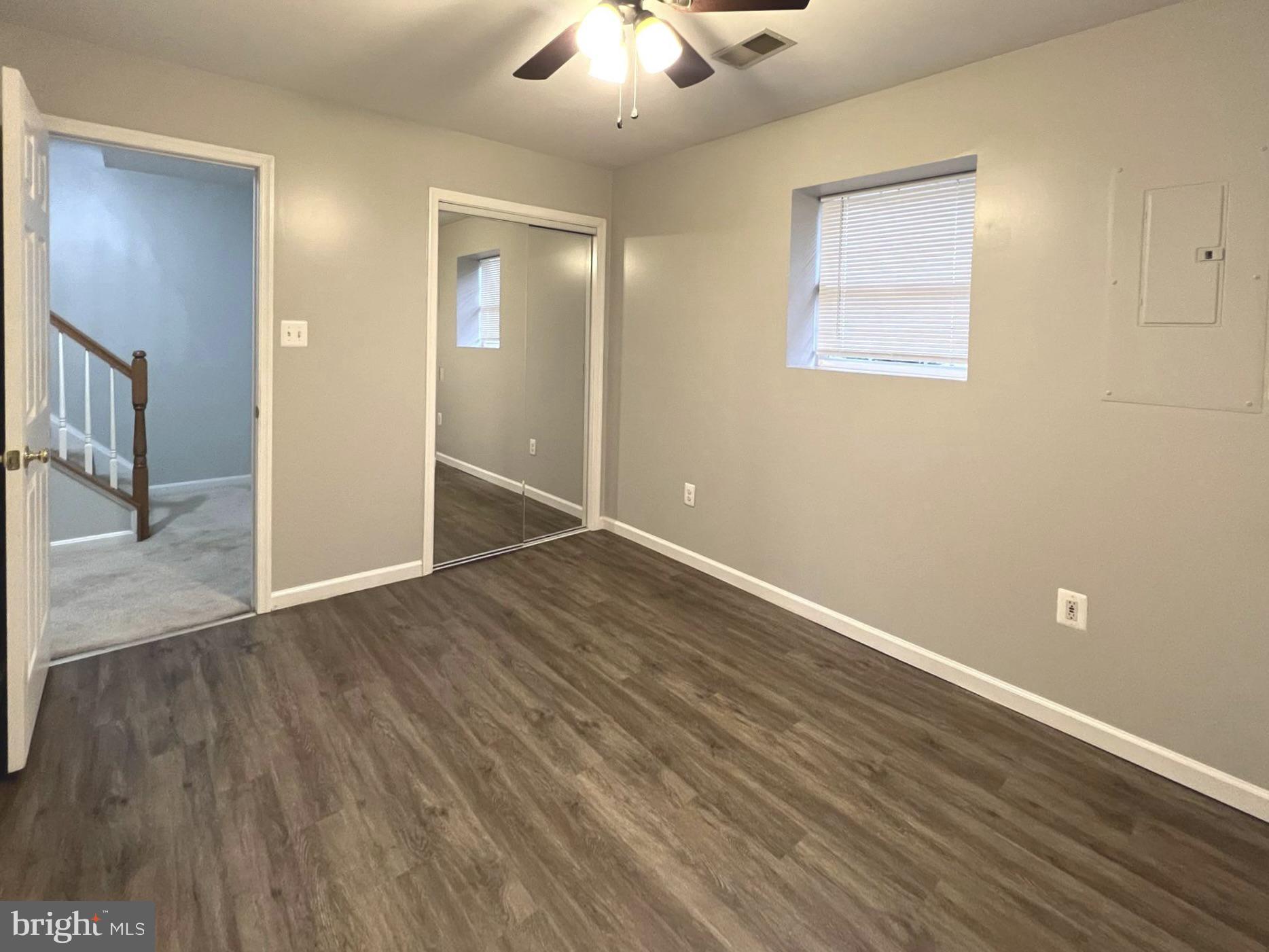2610 Streamview Drive Odenton, MD 21113 - Photo 20 of 23 an empty room with wooden floor and a chandelier fan