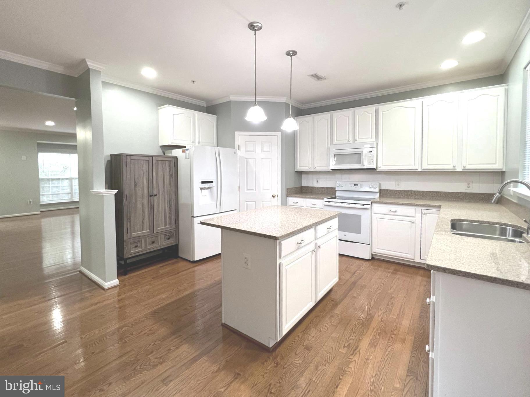 2610 Streamview Drive Odenton, MD 21113 - Photo 6 of 23 a kitchen with stainless steel appliances granite countertop a sink a stove a refrigerator and island with wooden floor