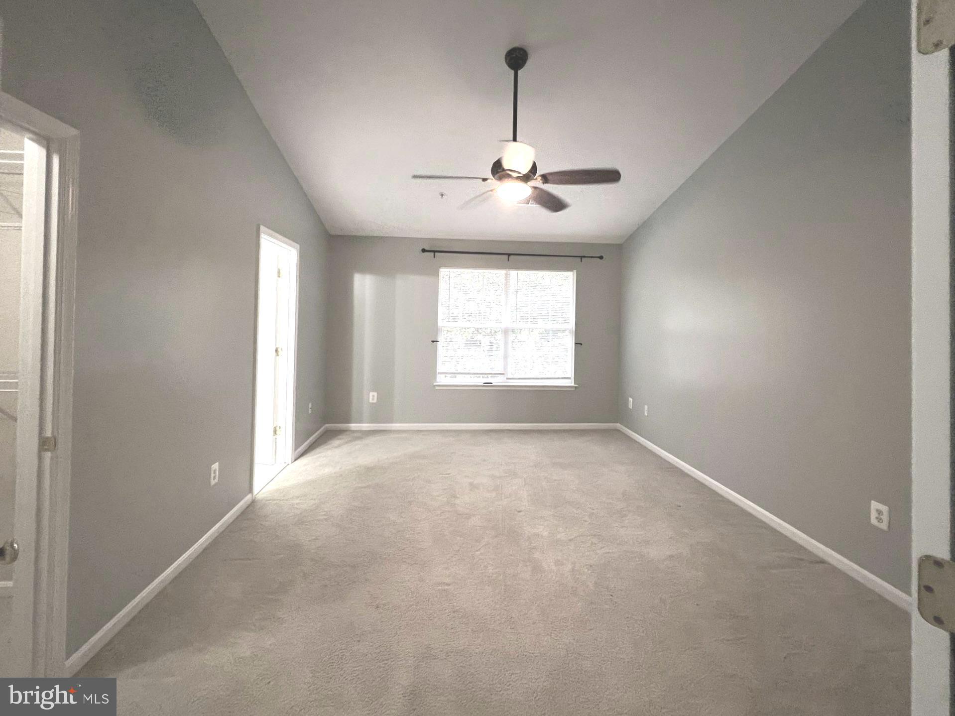 2610 Streamview Drive Odenton, MD 21113 - Photo 8 of 23 en empty room with windows and chandelier fan