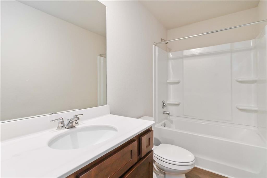 10794 Wheeler Trace Hampton, GA 30228 - Photo 30 of 35 a bathroom with a sink toilet and shower