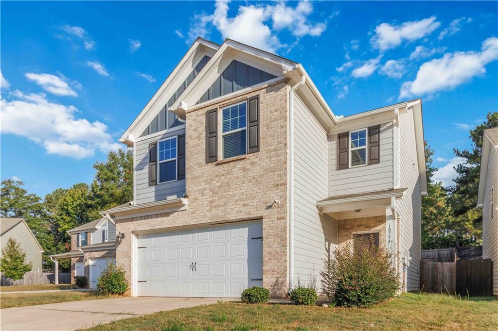 10794 Wheeler Trace Hampton, GA 30228 - Photo 3 of 35 a front view of a house with a yard