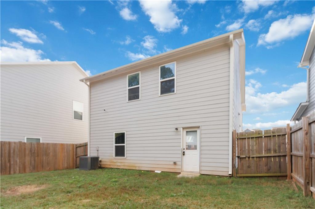10794 Wheeler Trace Hampton, GA 30228 - Photo 32 of 35 a backyard of a house with lots of green space