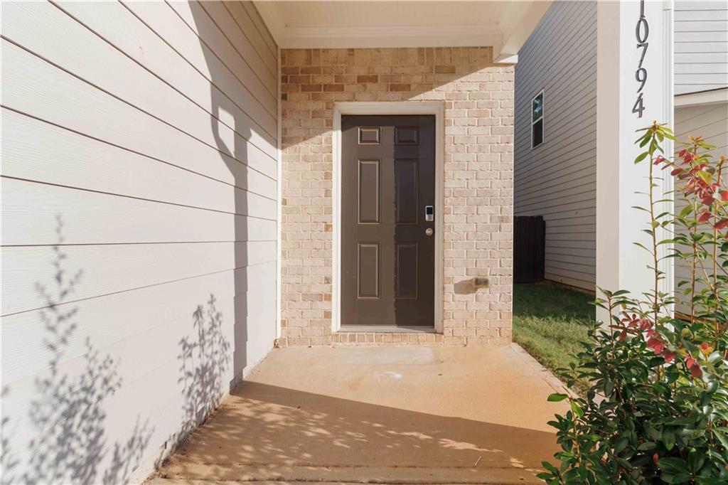 10794 Wheeler Trace Hampton, GA 30228 - Photo 4 of 35 a front view of a house with a yard