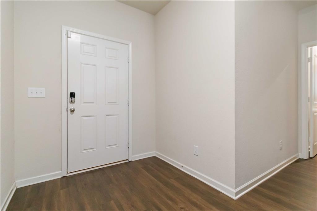 10794 Wheeler Trace Hampton, GA 30228 - Photo 5 of 35 a view of an empty room with wooden floor