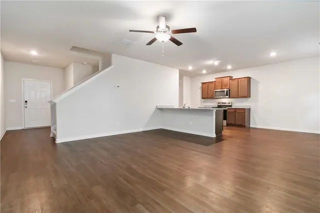 a view of kitchen with wooden floor and a ceiling fan