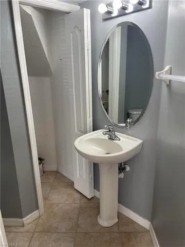 a white sink sitting in a bathroom next to a sink
