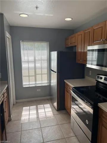 a kitchen with a stove a microwave and a refrigerator