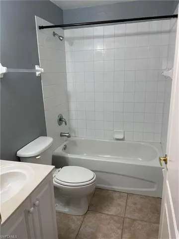 a bathroom with a toilet and a bathtub