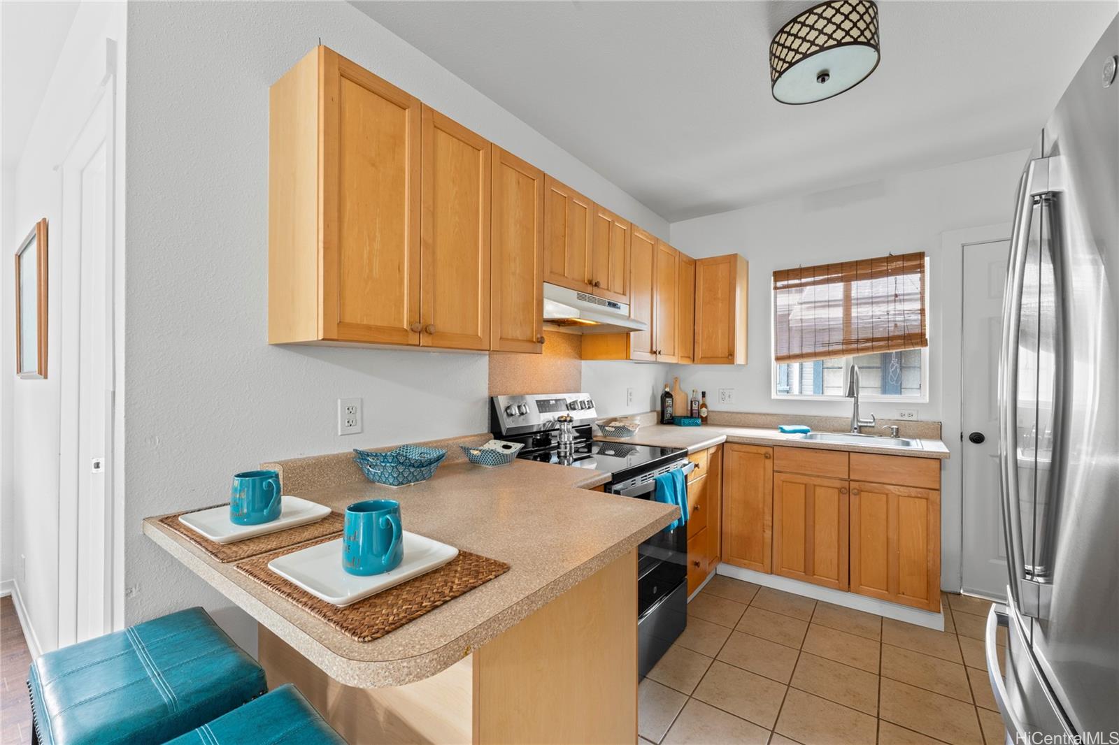 1506 Frear Street, Unit A Honolulu, HI 96813 - Photo 6 of 25 Functional kitchen with warm wood cabinetry and plenty of counter space for meal prep.