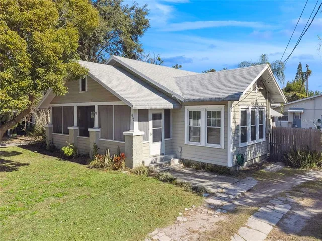 a front view of house with yard outdoor seating and barbeque oven