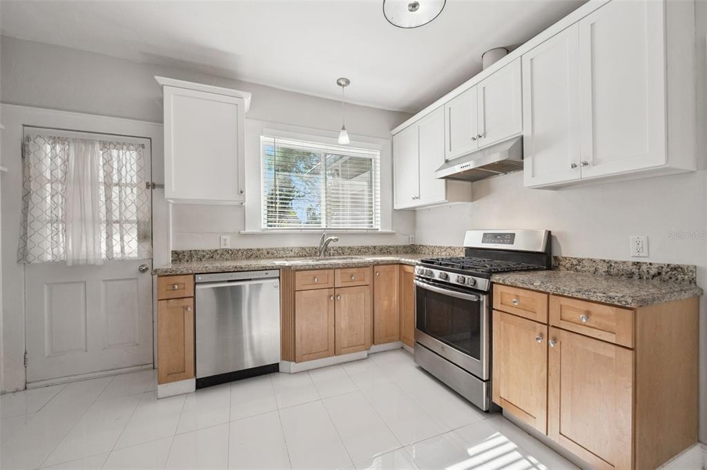 352 Cambridge Boulevard Winter Park, FL 32789 - Photo 11 of 35 a kitchen with stainless steel appliances granite countertop a stove and a sink