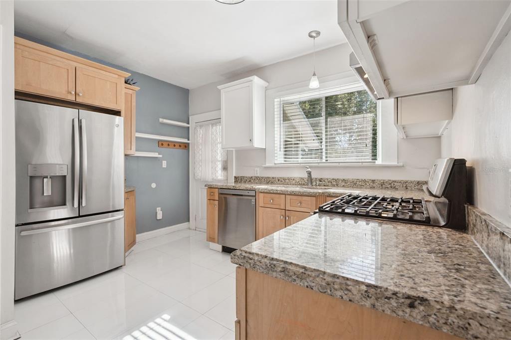 352 Cambridge Boulevard Winter Park, FL 32789 - Photo 13 of 35 a kitchen with granite countertop a refrigerator and a sink