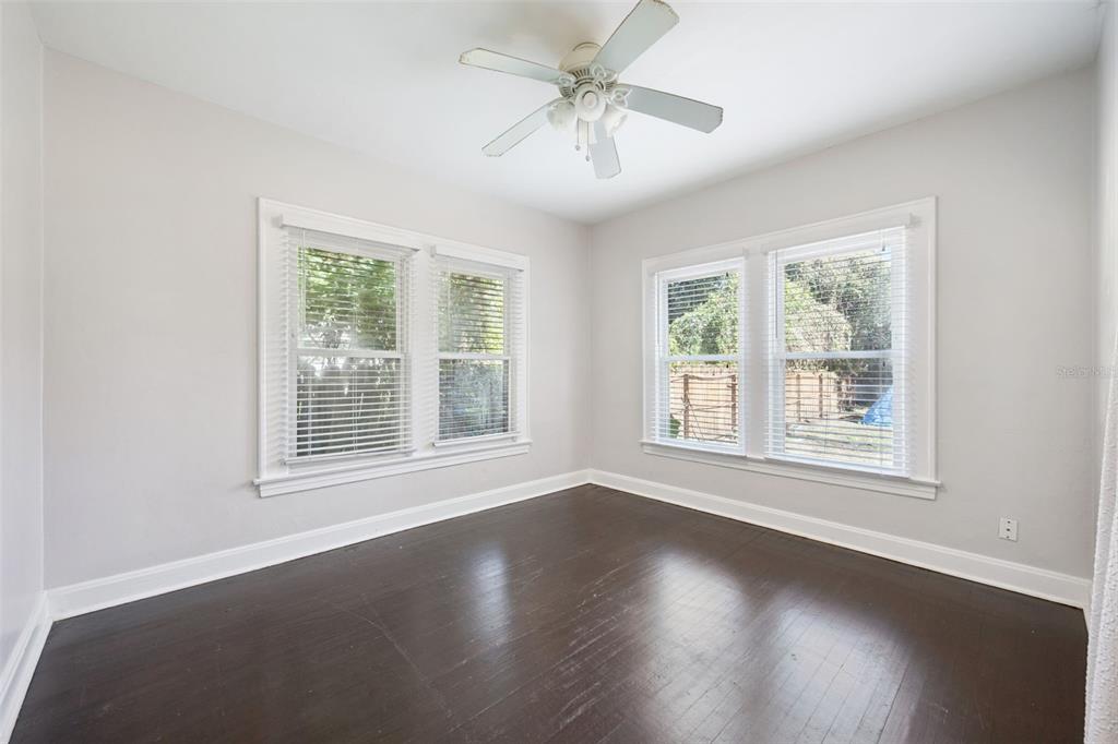 352 Cambridge Boulevard Winter Park, FL 32789 - Photo 17 of 35 a view of an empty room with wooden floor and a window