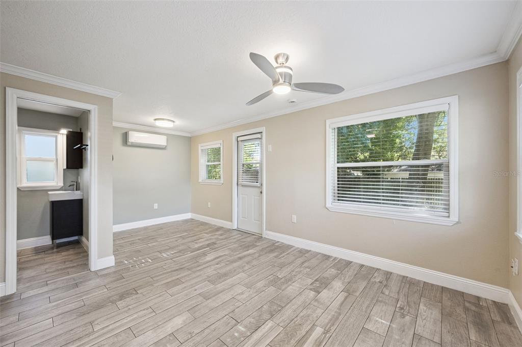 352 Cambridge Boulevard Winter Park, FL 32789 - Photo 24 of 35 a view of an empty room with a window and wooden floor