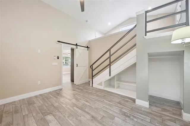 a view of a room with wooden floor and white walls