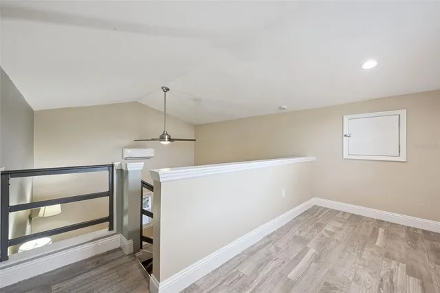 a view of storage and utility room with wooden floor