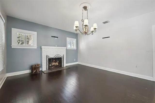 a view of a livingroom with wooden floor a fireplace