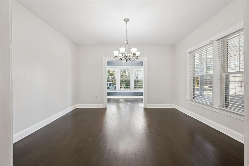 352 Cambridge Boulevard Winter Park, FL 32789 - Photo 7 of 35 a view of a room with wooden floor chandeliers and a window