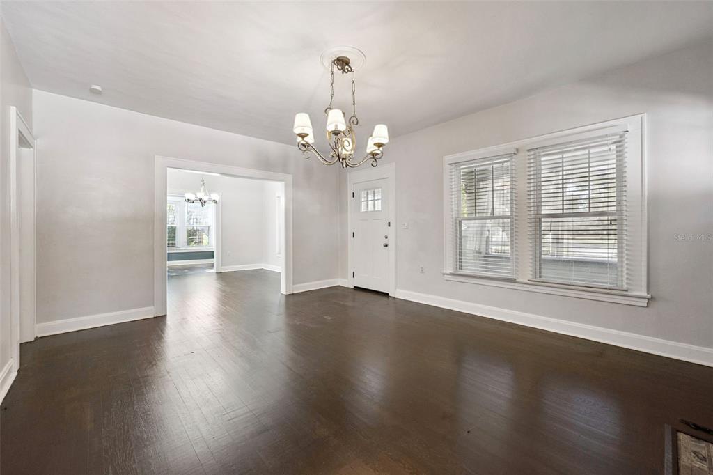 352 Cambridge Boulevard Winter Park, FL 32789 - Photo 8 of 35 a view of an empty room with wooden floor and a window