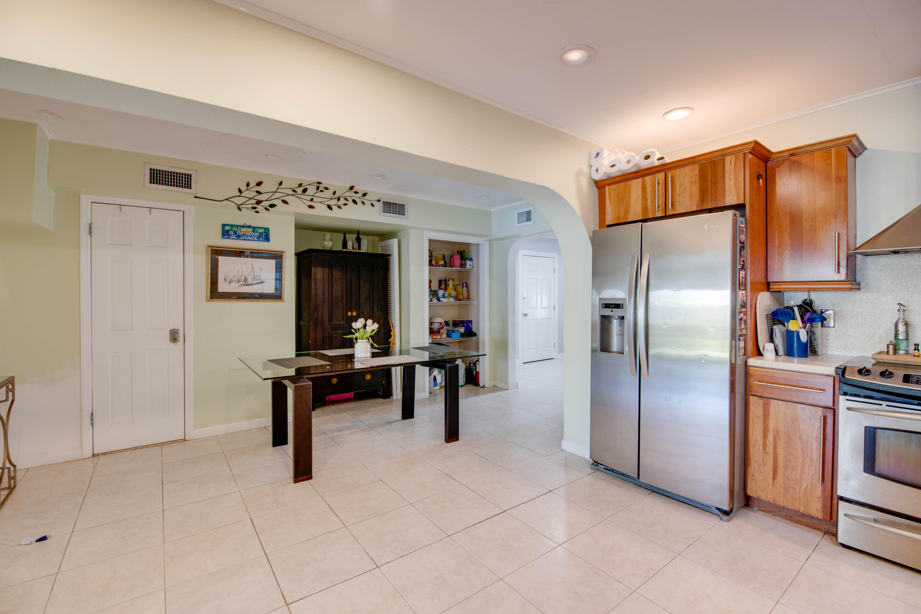 3341 Riviera Drive Key West, FL 33040 - Photo 12 of 33 a kitchen with stainless steel appliances kitchen island granite countertop a refrigerator and a sink
