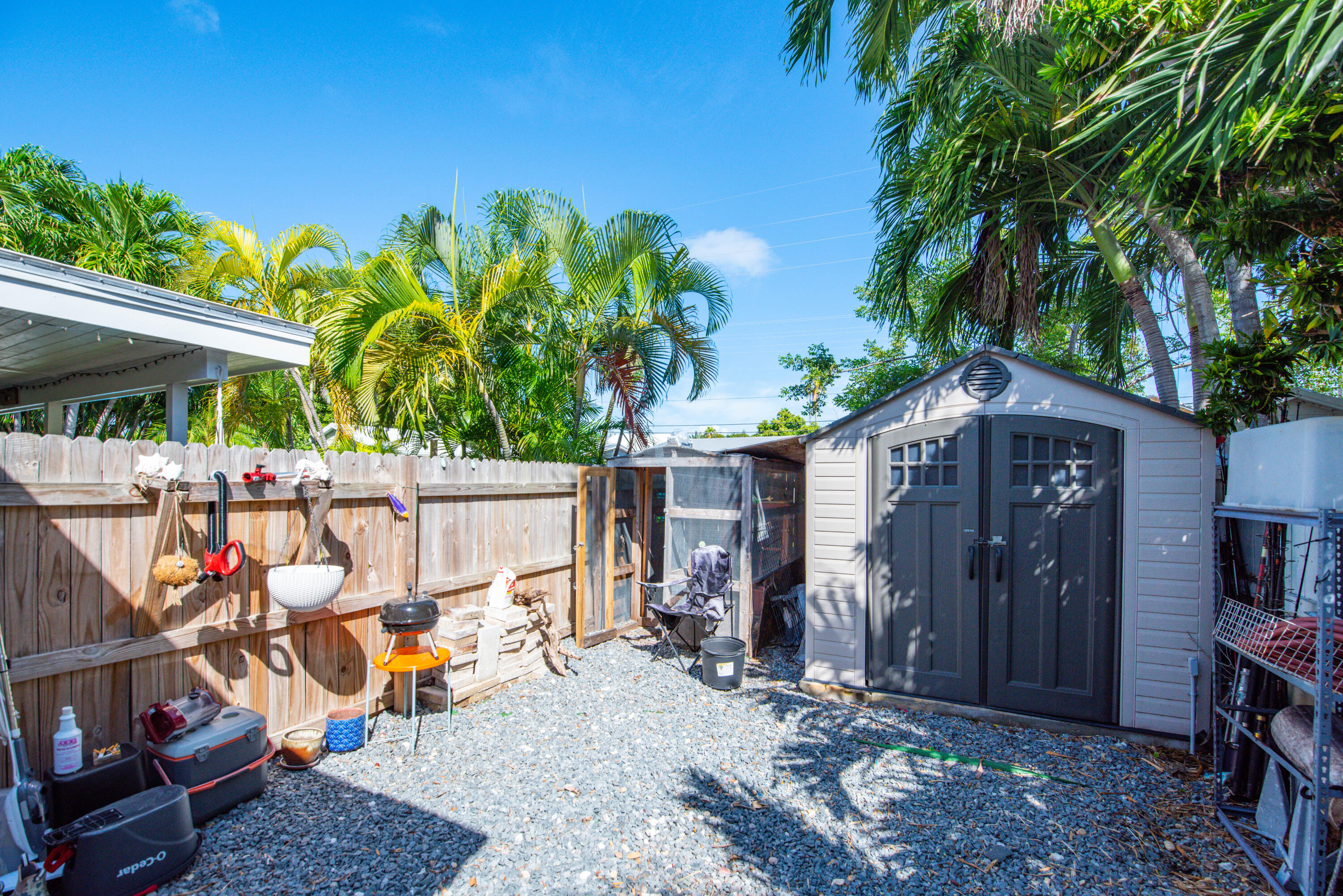 3341 Riviera Drive Key West, FL 33040 - Photo 32 of 33 a view of a patio with table and chairs potted plants and a large tree