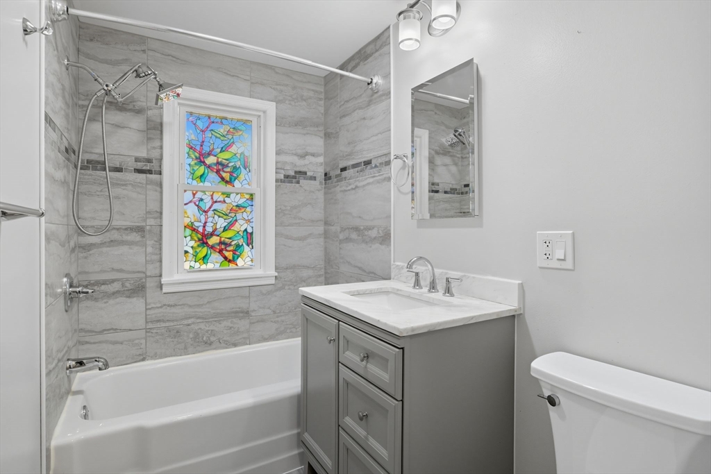 22 Colorado Street Springfield, MA 01118 - Photo 16 of 39 a bathroom with a sink mirror vanity and bathtub