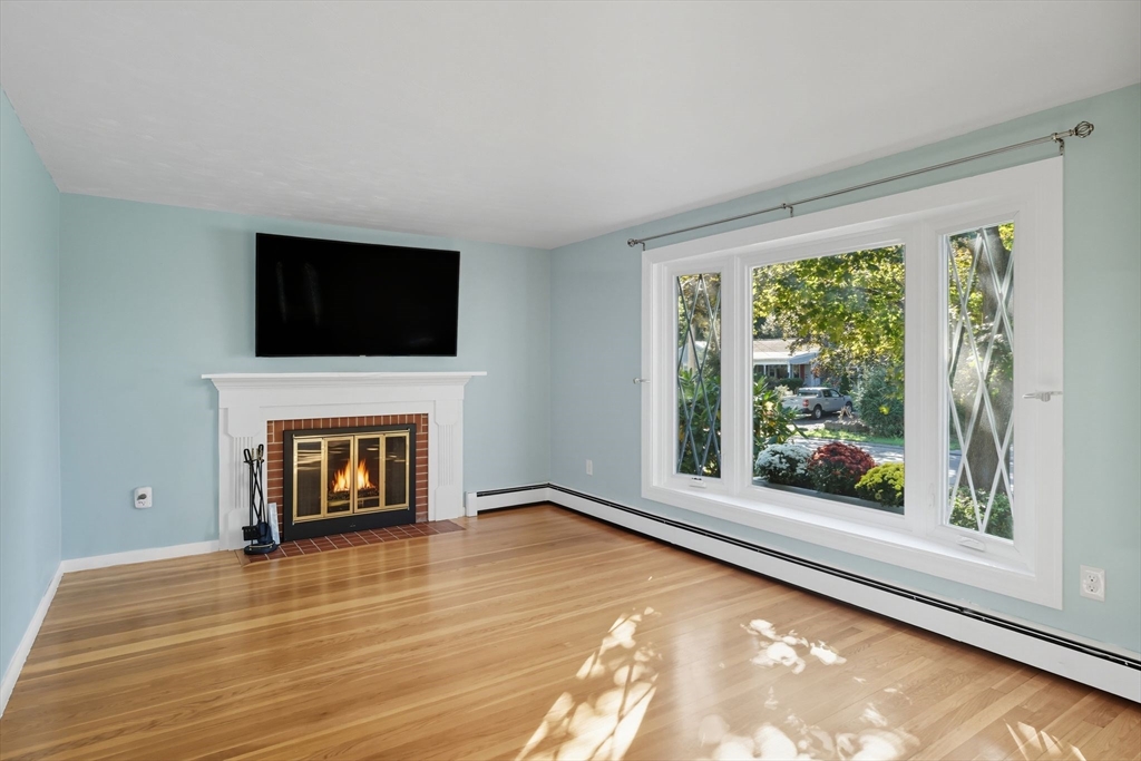 22 Colorado Street Springfield, MA 01118 - Photo 3 of 39 a living room with fireplace and a flat screen tv