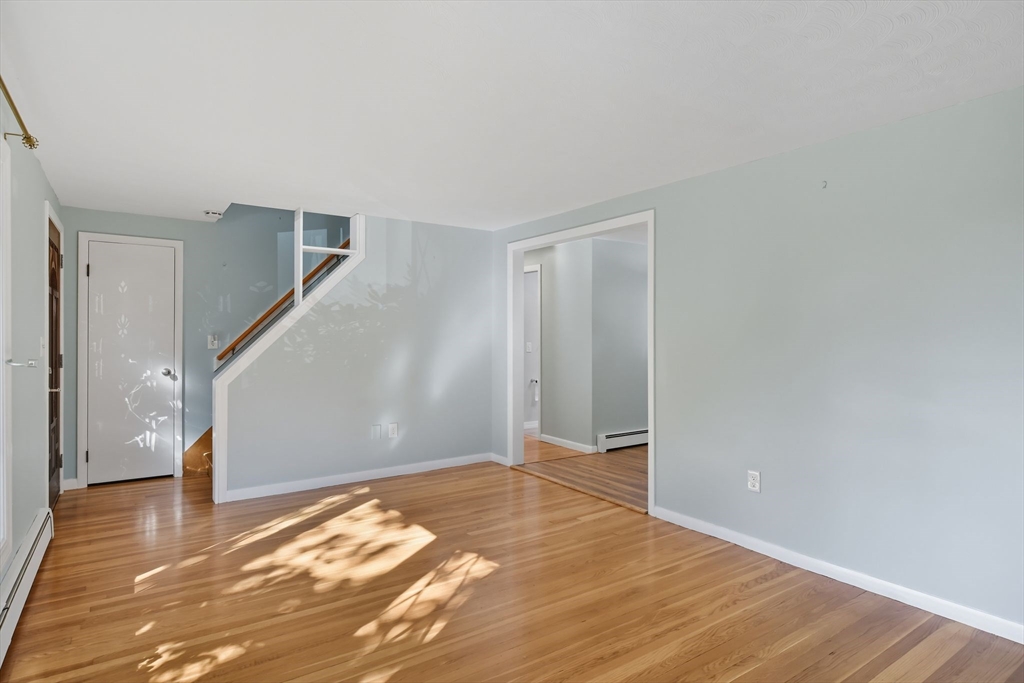 22 Colorado Street Springfield, MA 01118 - Photo 5 of 39 a view of an empty room with wooden floor and stairs