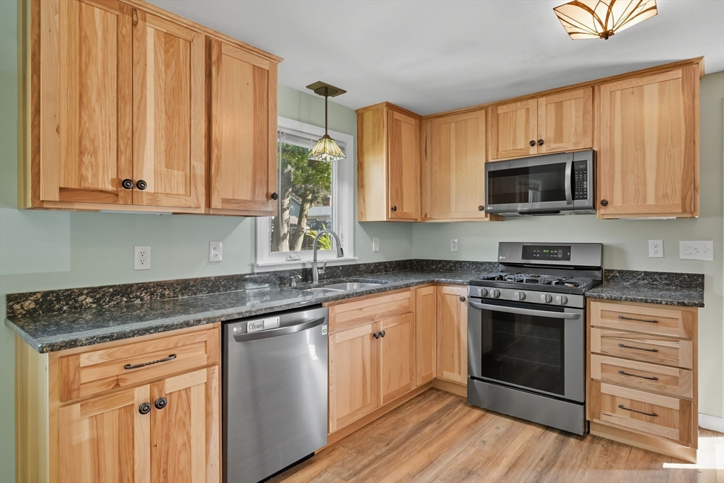 22 Colorado Street Springfield, MA 01118 - Photo 6 of 39 a kitchen with stainless steel appliances granite countertop a stove a sink and a microwave