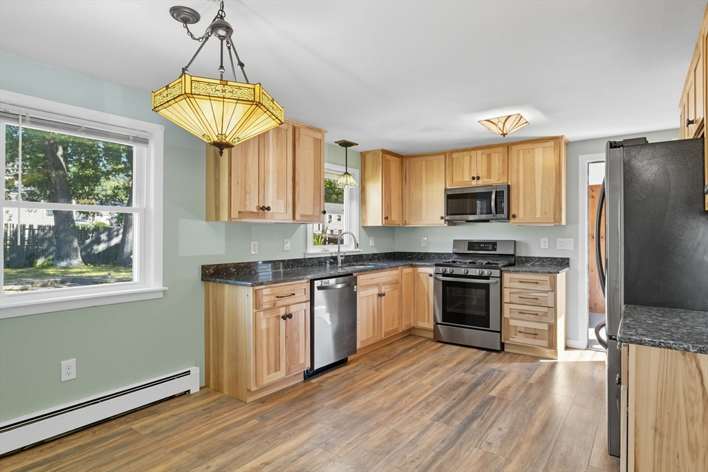 22 Colorado Street Springfield, MA 01118 - Photo 8 of 39 a kitchen with stainless steel appliances a stove a refrigerator and a sink