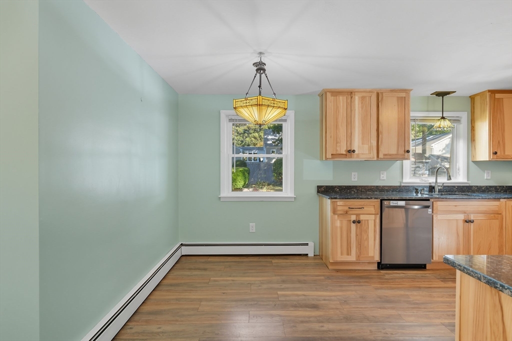 22 Colorado Street Springfield, MA 01118 - Photo 9 of 39 a kitchen with granite countertop wooden floors a sink stainless steel appliances and a window