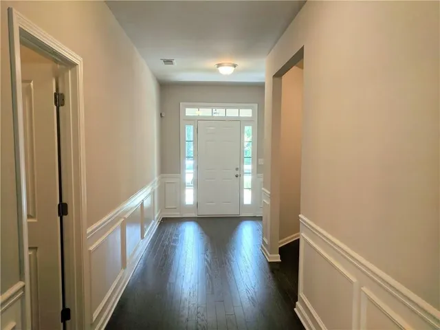 a view of hallway with wooden floor