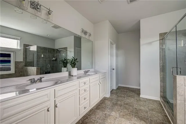 a spacious bathroom with a double vanity sink mirror and double