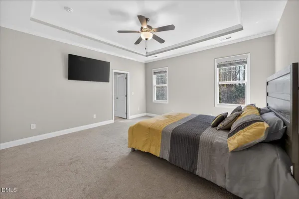 a bedroom with a bed and a ceiling fan