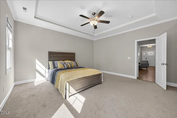 a bedroom with a large bed and a tv