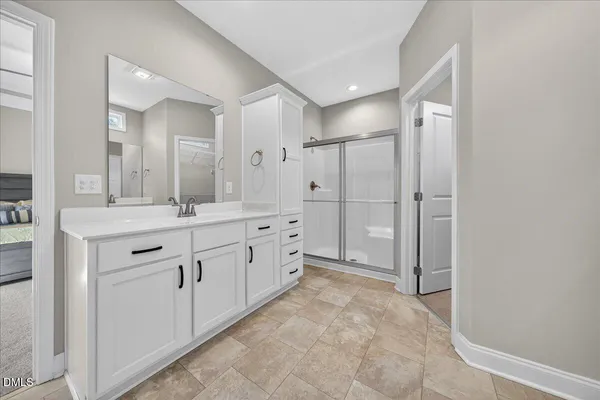 a spacious bathroom with a granite countertop sink mirror and a