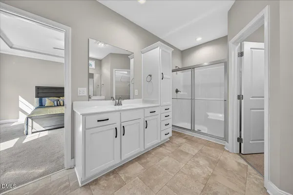 a bathroom with a sink vanity and a mirror