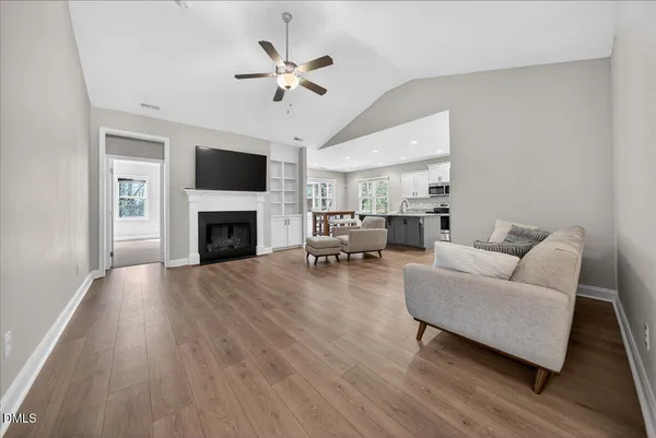 a living room with furniture and kitchen view