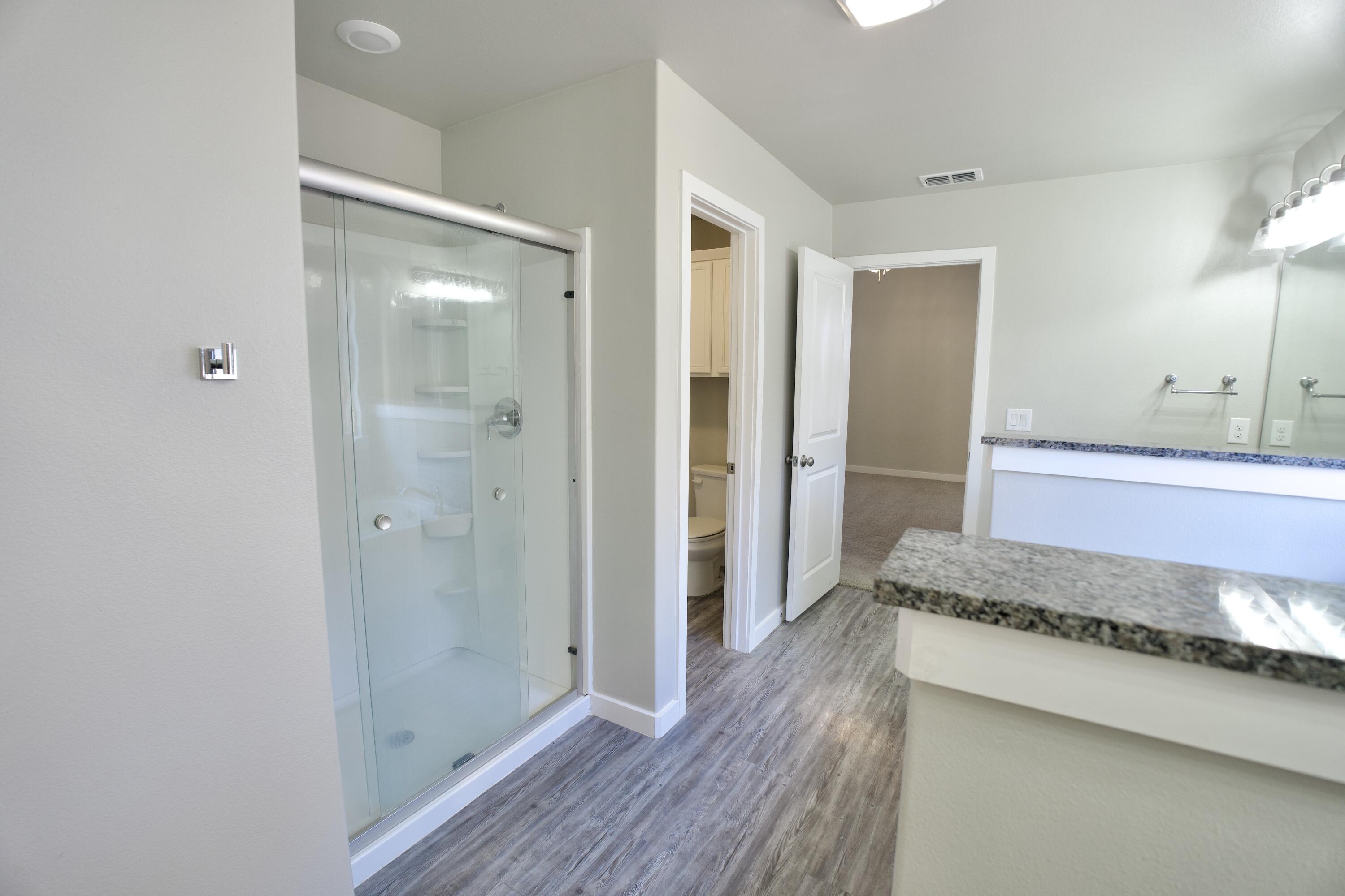 1604 137th Street Lubbock, TX 79423 - Photo 12 of 19 a bathroom with a mirror and a shower