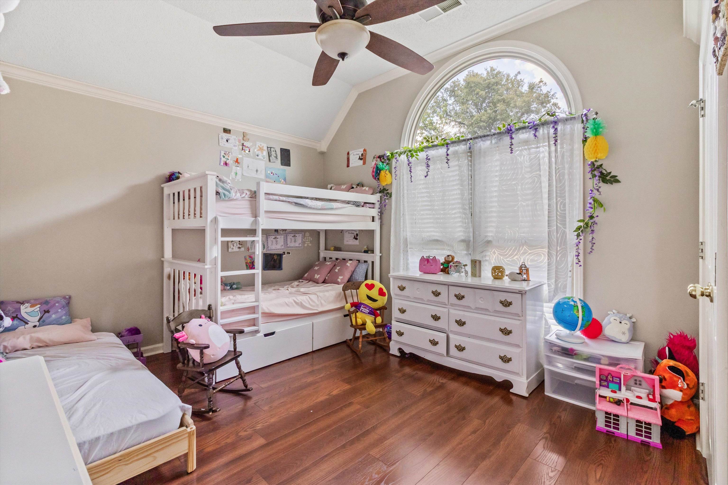 8821 Bazemore Road Memphis, TN 38018 - Photo 15 of 26 Bedroom with dark wood-type flooring, vaulted ceiling, a ceiling fan, and crown molding