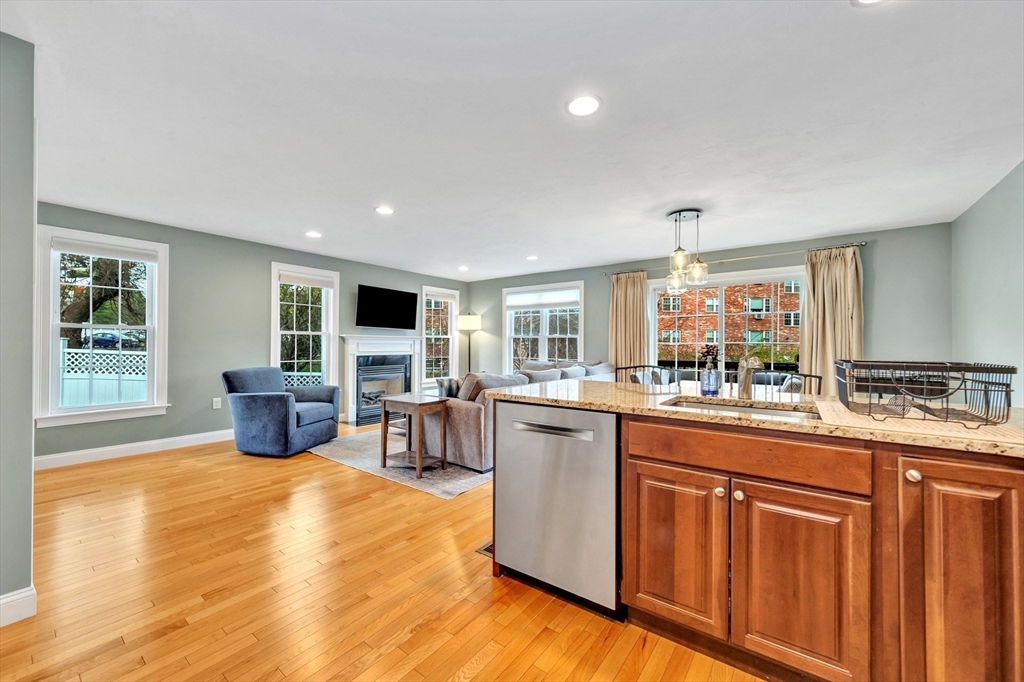 24 River Point Drive, Unit 6 Ipswich, MA 01938 - Photo 11 of 27 a kitchen with stainless steel appliances kitchen island granite countertop a stove top oven a sink dishwasher and cabinets with wooden floor