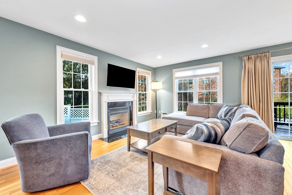 24 River Point Drive, Unit 6 Ipswich, MA 01938 - Photo 7 of 27 a living room with furniture a flat screen tv and a fireplace