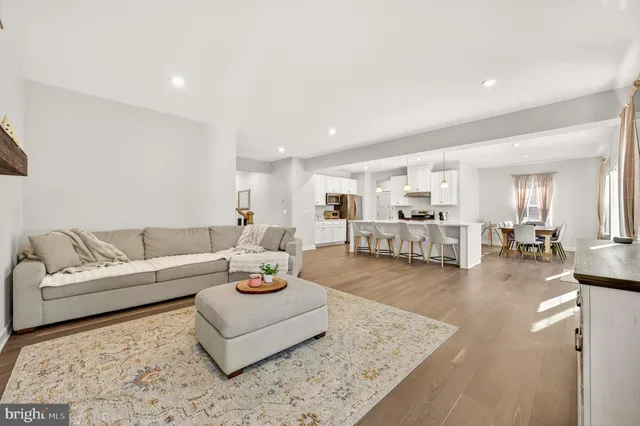 a kitchen with a dining table chairs refrigerator and cabinets