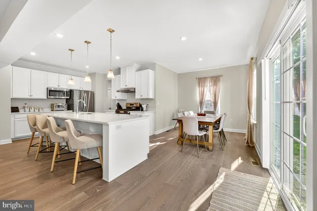 a kitchen with stainless steel appliances granite countertop a stove and a sink